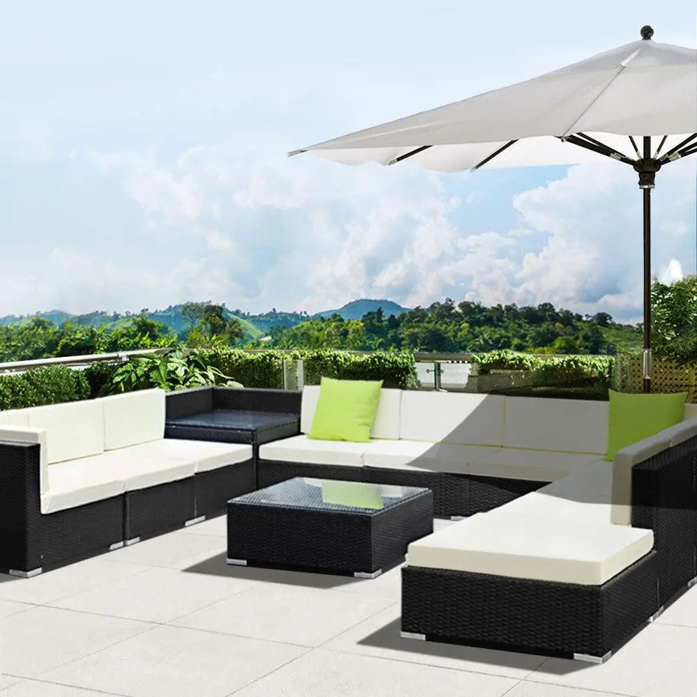 Gardeon 12PC Outdoor Furniture Set featuring wicker sofa lounge with cushions and a glass-top table, perfect for outdoor relaxation.