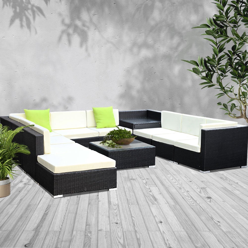 Gardeon 11PC Outdoor Furniture Sofa Set featuring black aluminum frame, beige cushions, and lime green throw pillows in a garden setting.