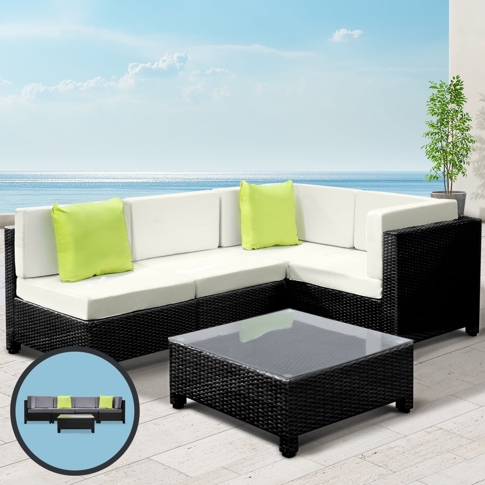 Gardeon 5PC Outdoor Furniture Sofa Set featuring modular wicker couches, a coffee table with tempered glass top, and vibrant cushions in a backyard setting.