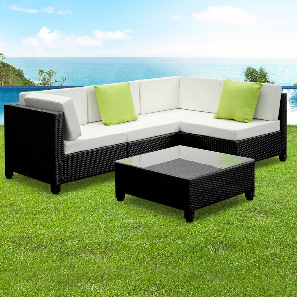 Gardeon 5PC Outdoor Furniture Sofa Set featuring modular wicker couches, a coffee table with tempered glass top, and vibrant cushions in a backyard setting.