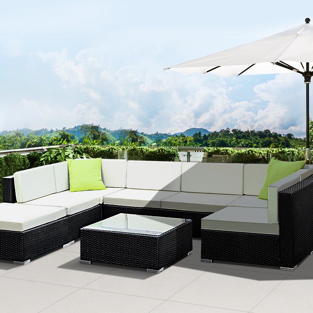 Gardeon 8PC Outdoor Sofa Set featuring black aluminium frame, beige cushions, and lime green throw pillows, with a glass-top table and ottoman.