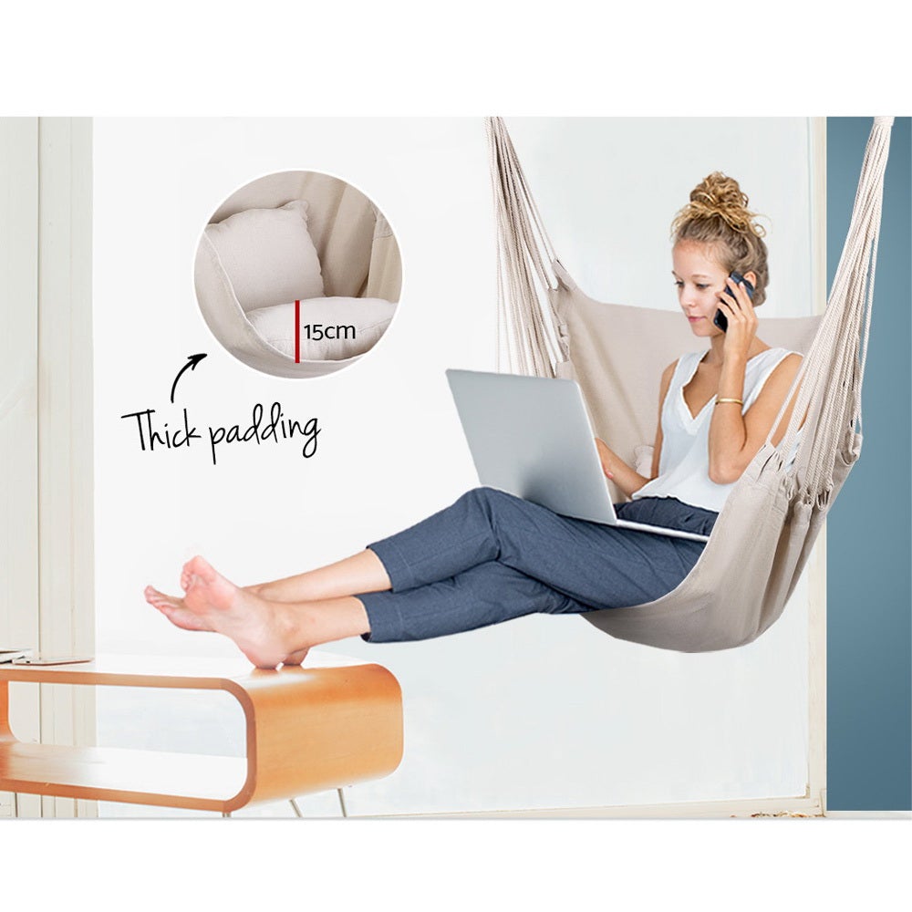 Gardeon Hammock Swing Chair in Cream color with matching cushions, hanging from a sturdy timber rail.