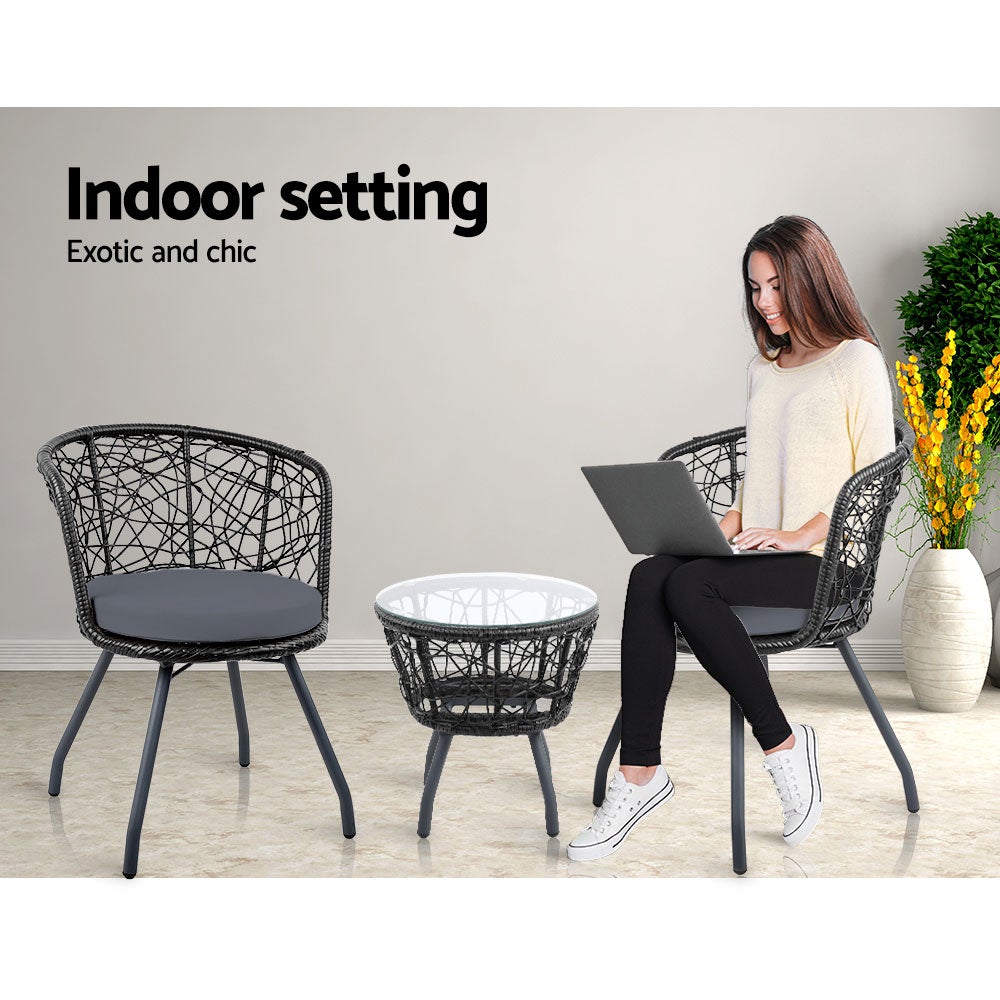 Gardeon Outdoor Patio Chair and Table set in black, featuring two rattan chairs with grey cushions and a matching side table with a glass top.