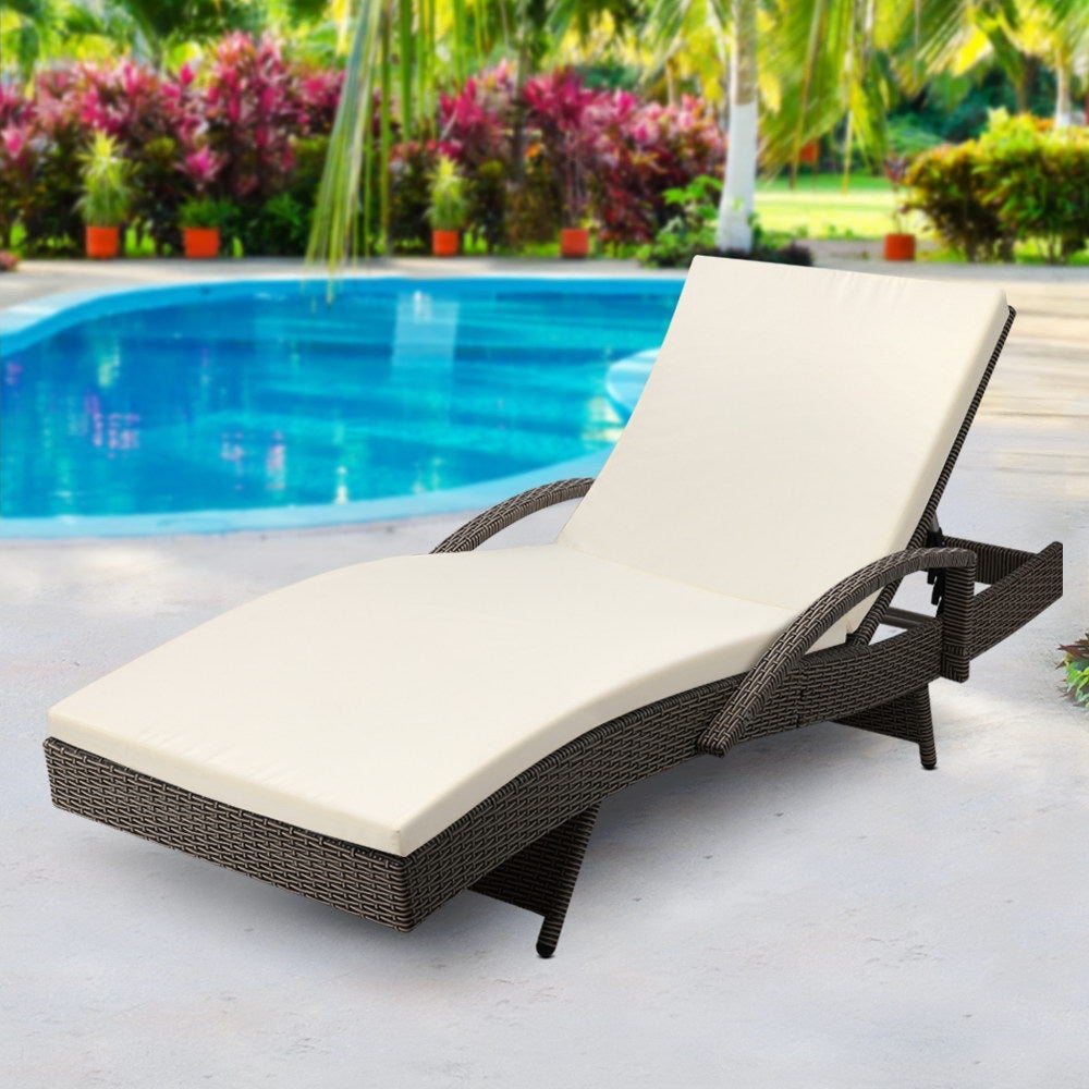 Gardeon Outdoor Sun Lounge in grey with beige cushions, featuring adjustable backrest and reversible armrests, set in a garden.