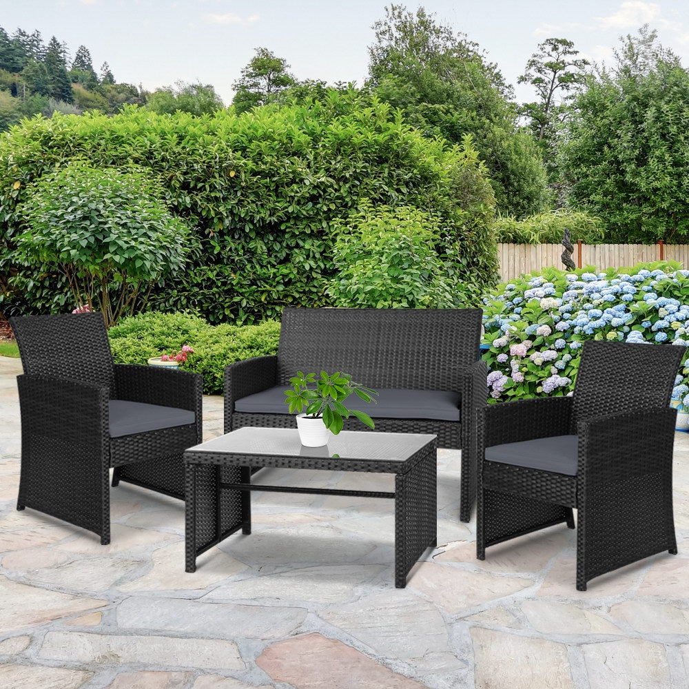 Gardeon Set of 4 Outdoor Wicker Chairs and Table in Black with grey cushions, showcasing a modern design suitable for outdoor and indoor use.