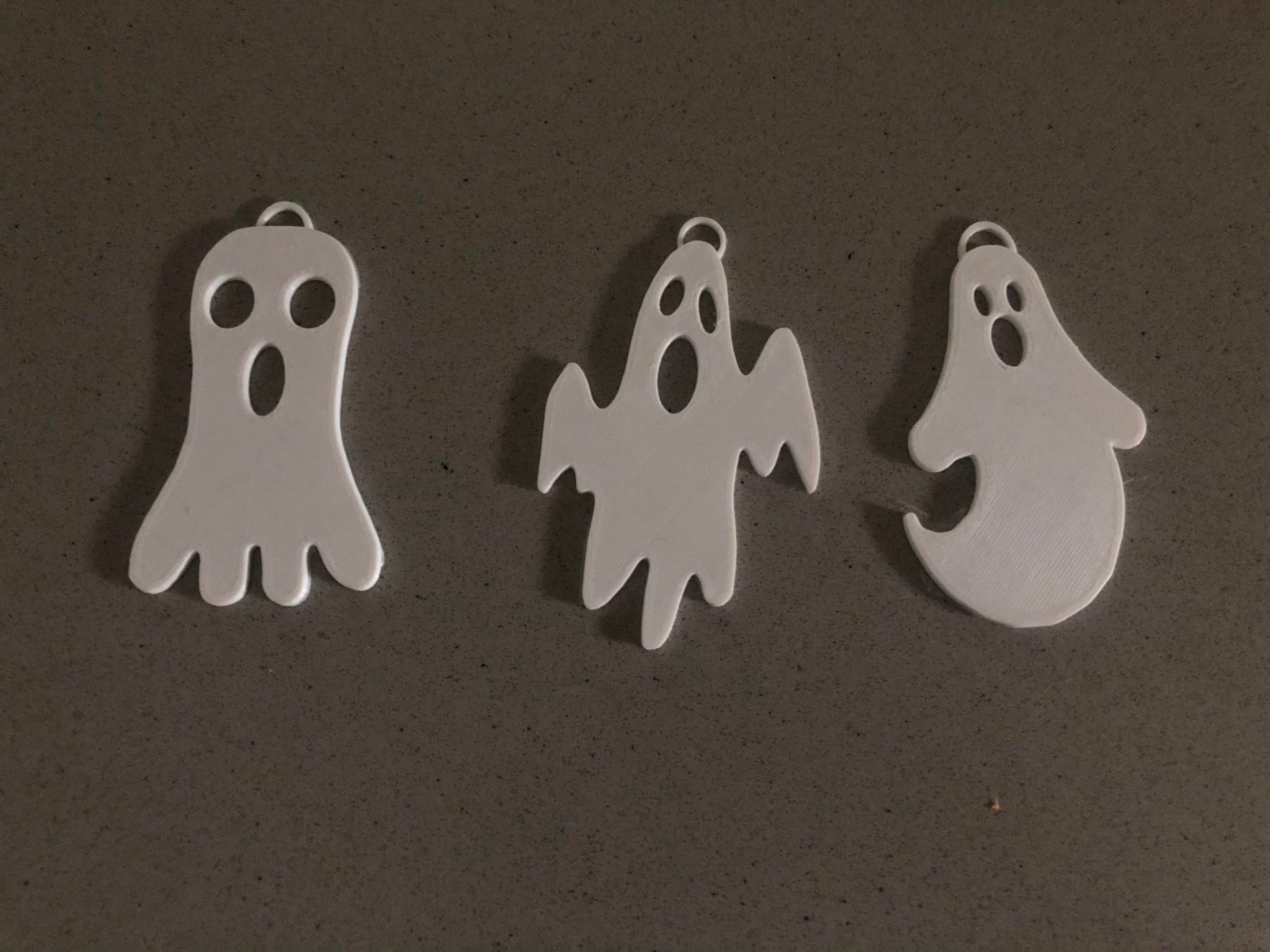 A collection of three unique ghost keychains in various styles, perfect for Halloween gifts and party favors.