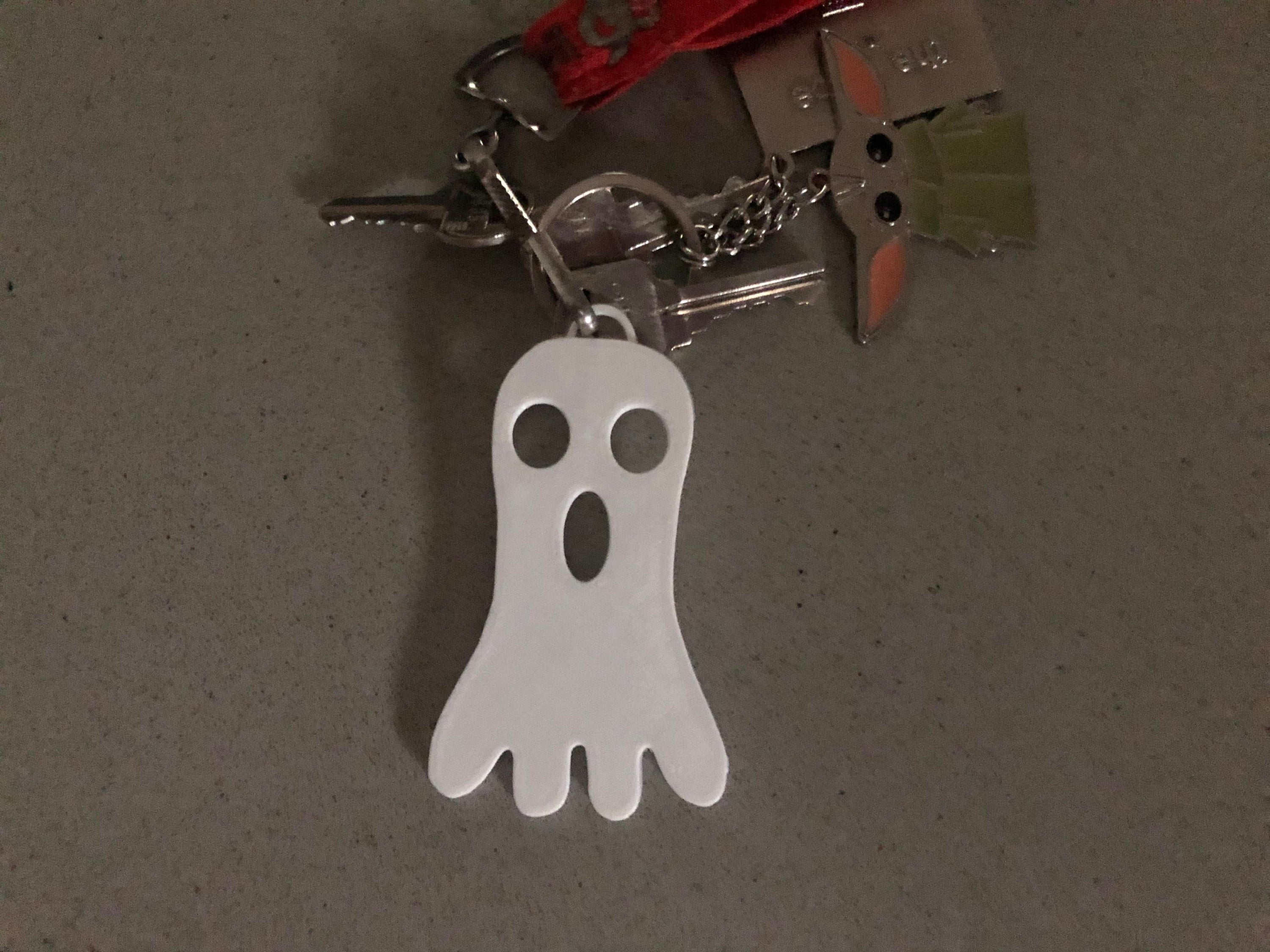 A collection of three unique ghost keychains in various styles, perfect for Halloween gifts and party favors.