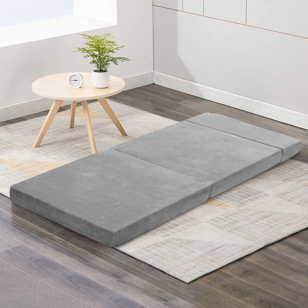 Giselle Bedding Folding Foam Mattress in light grey, showcasing its plush velvet fabric and foldable design.