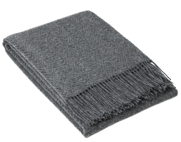 Hampton Throw blanket in slate color, made from Merino wool blend, elegantly draped on a cozy sofa.