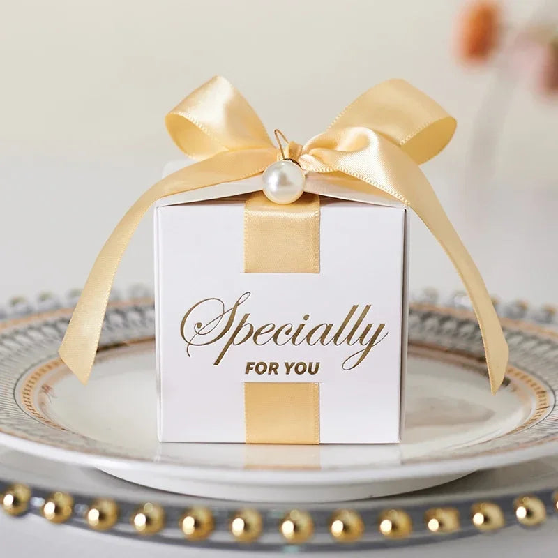 High quality square candy boxes decorated with pearls and ribbons, ideal for weddings and special occasions, showcasing elegant design and sturdy construction.