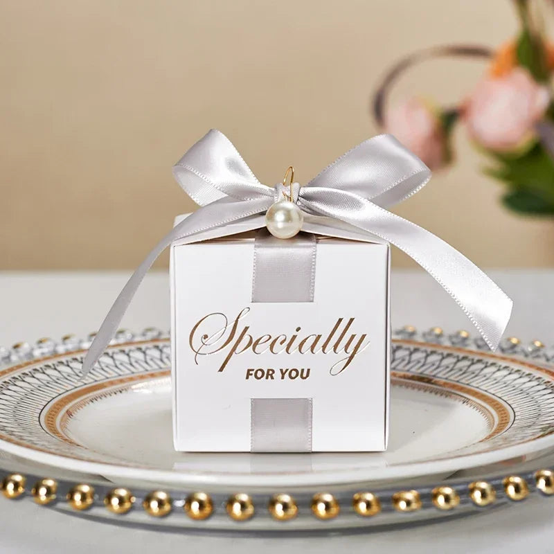 High quality square candy boxes decorated with pearls and ribbons, ideal for weddings and special occasions, showcasing elegant design and sturdy construction.