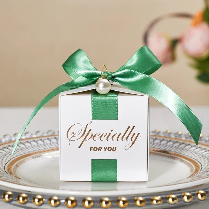 High quality square candy boxes decorated with pearls and ribbons, ideal for weddings and special occasions, showcasing elegant design and sturdy construction.