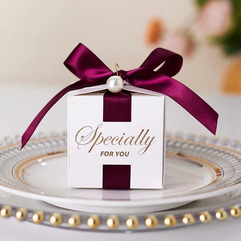 High quality square candy boxes decorated with pearls and ribbons, ideal for weddings and special occasions, showcasing elegant design and sturdy construction.