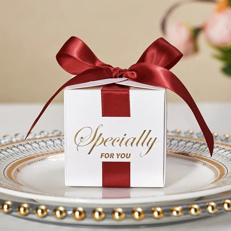 High quality square candy boxes decorated with pearls and ribbons, ideal for weddings and special occasions, showcasing elegant design and sturdy construction.