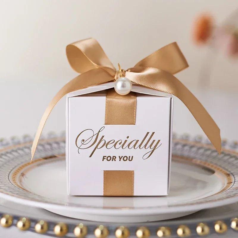 High quality square candy boxes decorated with pearls and ribbons, ideal for weddings and special occasions, showcasing elegant design and sturdy construction.