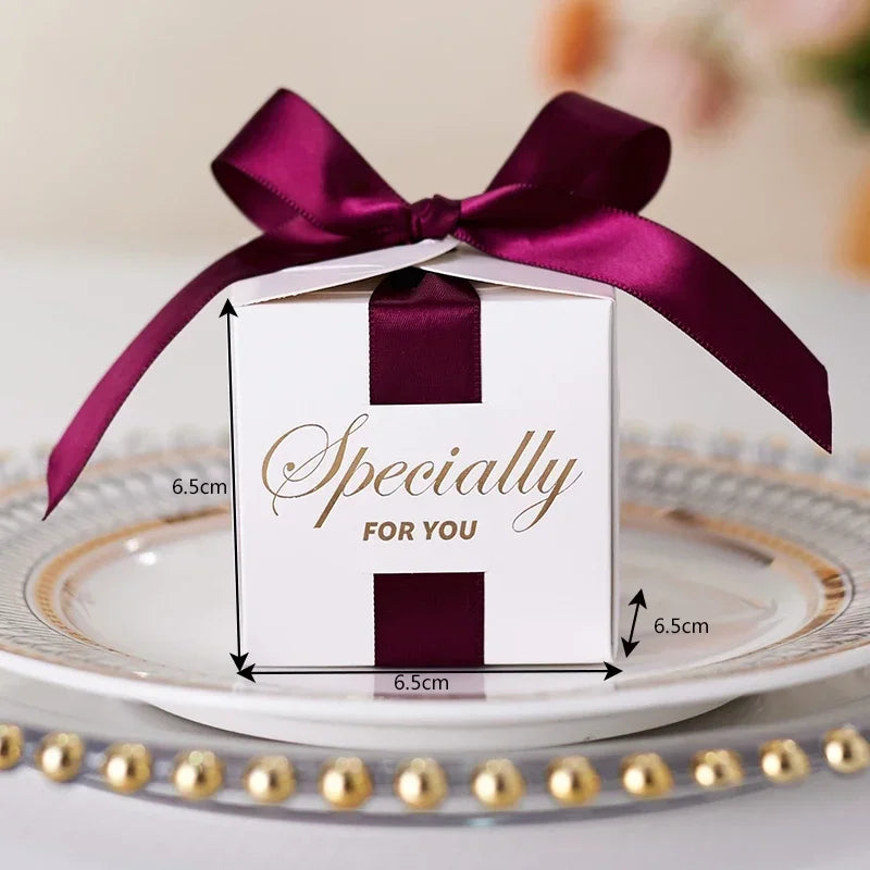 High quality square candy boxes decorated with pearls and ribbons, ideal for weddings and special occasions, showcasing elegant design and sturdy construction.