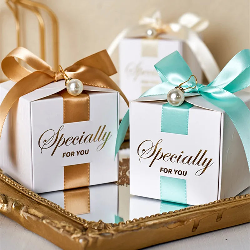 High quality square candy boxes decorated with pearls and ribbons, ideal for weddings and special occasions, showcasing elegant design and sturdy construction.