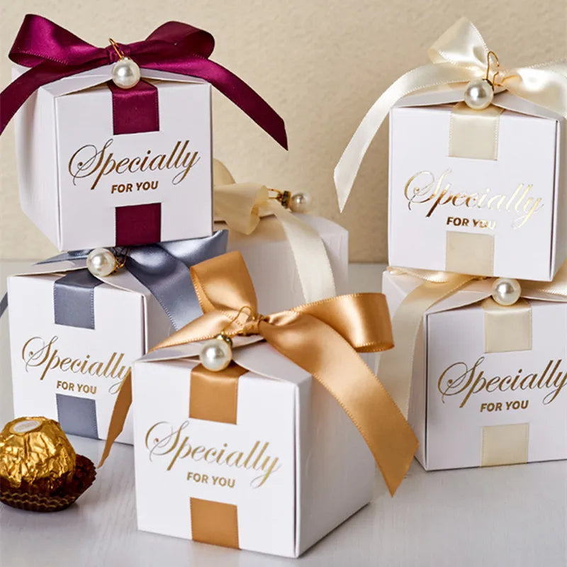 High quality square candy boxes decorated with pearls and ribbons, ideal for weddings and special occasions, showcasing elegant design and sturdy construction.