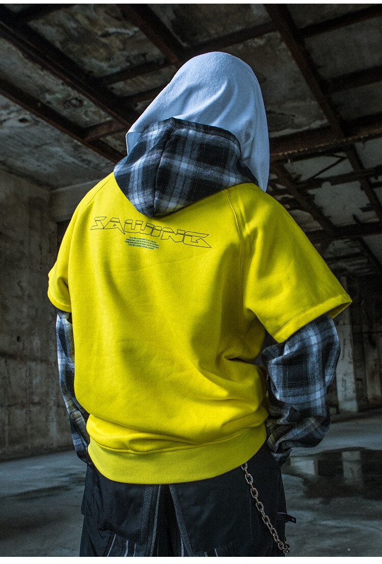 Men's oversized hooded pullover featuring plaid print sleeves in black and yellow, perfect for streetwear style.