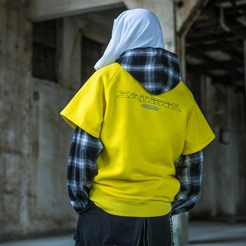 Men's oversized hooded pullover featuring plaid print sleeves in black and yellow, perfect for streetwear style.