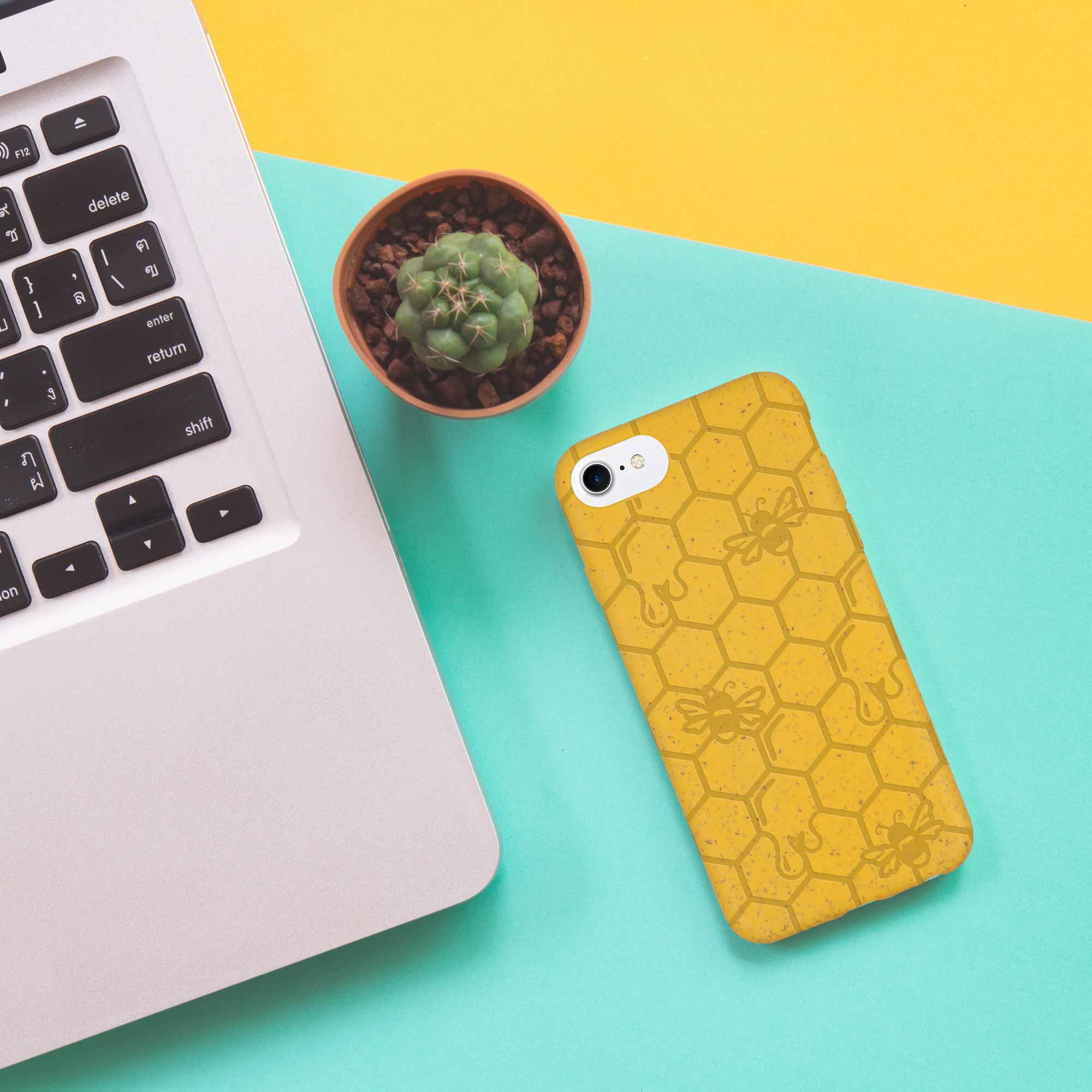 Honey Bee Biodegradable phone case in yellow, orange, and black with a bee hive engraving, showcasing its eco-friendly design.