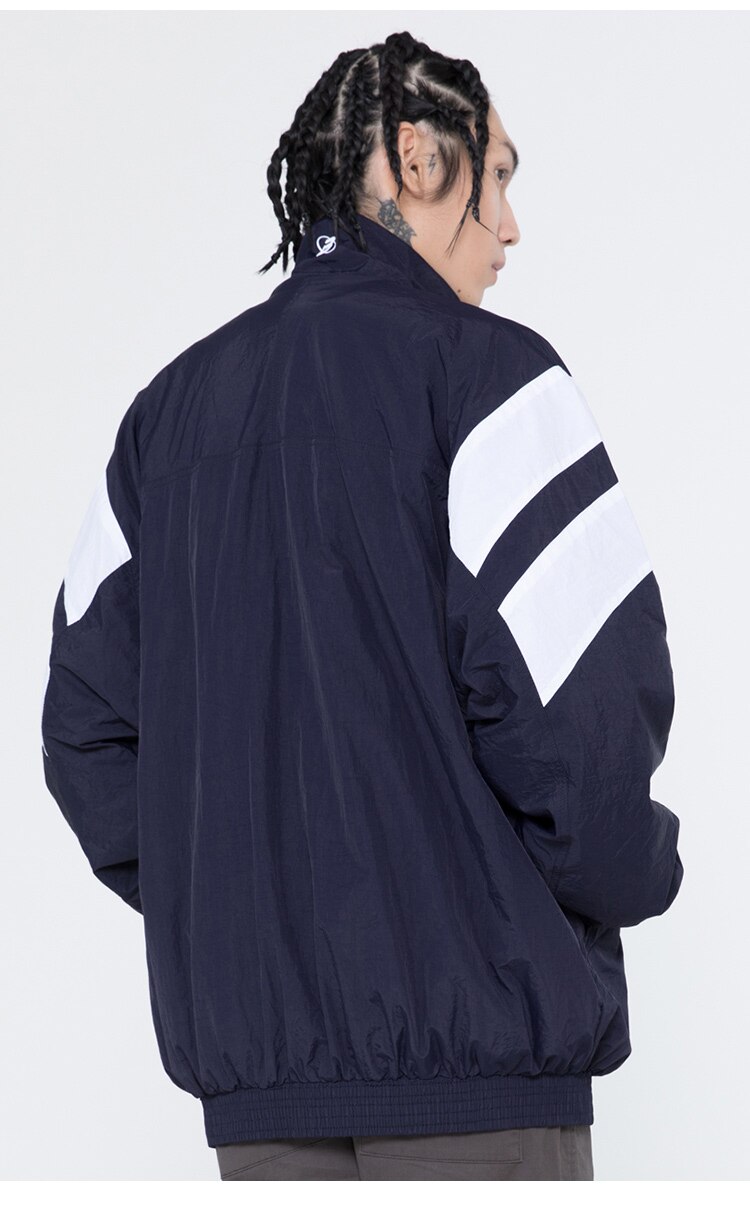 Men's oversized windbreaker coat featuring letter embroidery and color block patchwork design, available in red, blue, and gray.