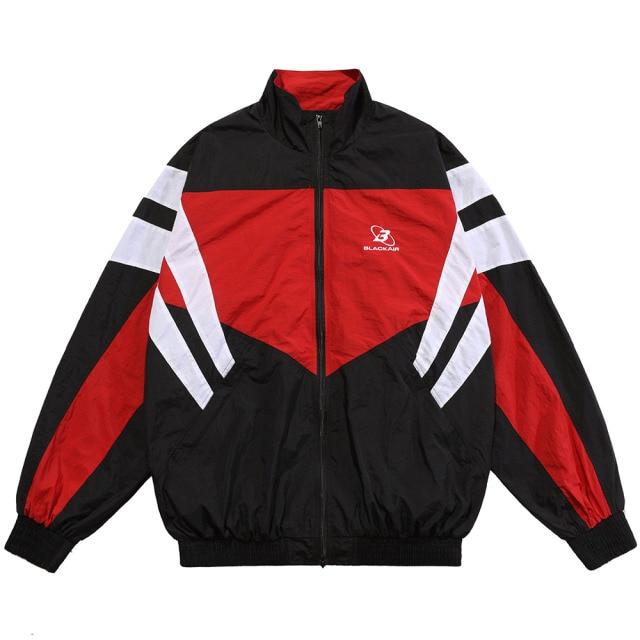 Men's oversized windbreaker coat featuring letter embroidery and color block patchwork design, available in red, blue, and gray.