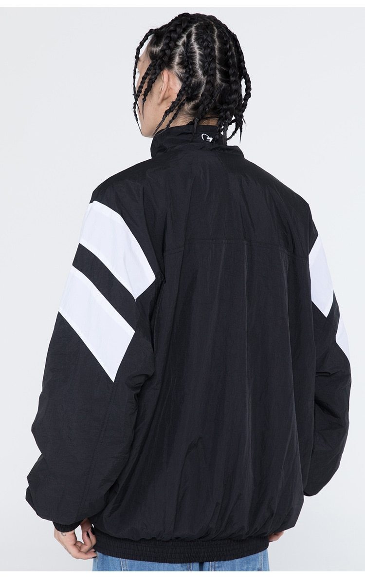 Men's oversized windbreaker coat featuring letter embroidery and color block patchwork design, available in red, blue, and gray.