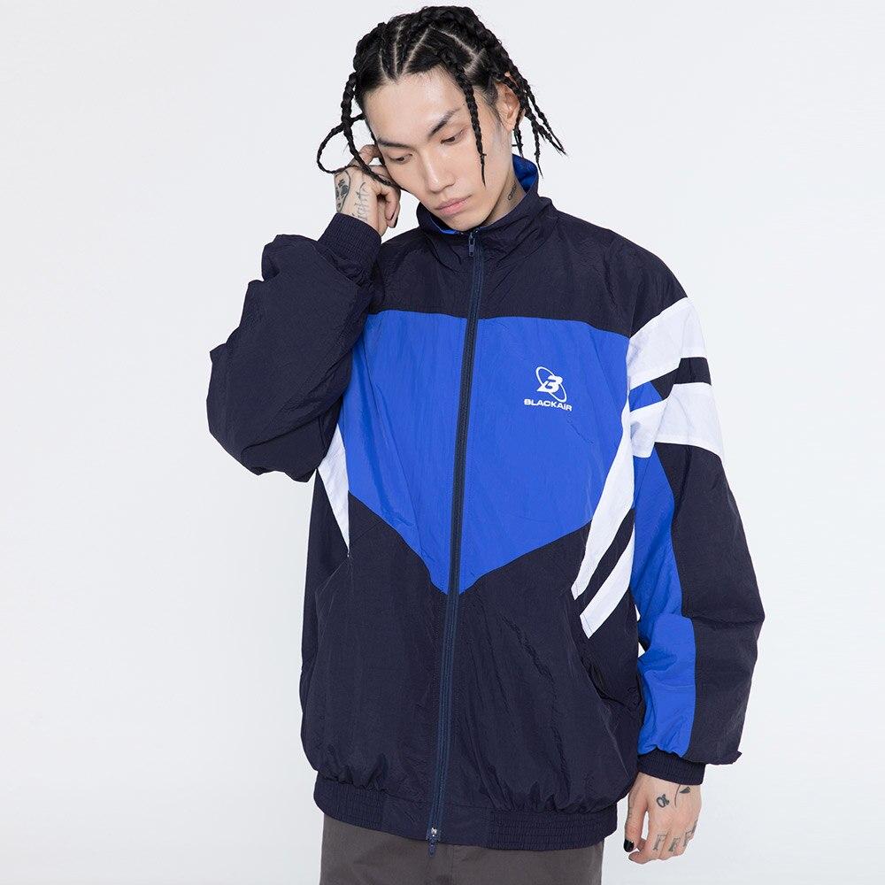 Men's oversized windbreaker coat featuring letter embroidery and color block patchwork design, available in red, blue, and gray.