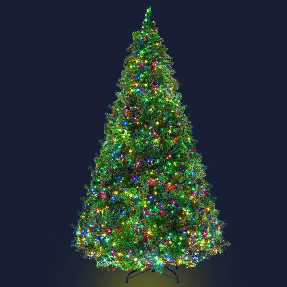 Jingle Jollys 2.4M LED Christmas Tree with multicoloured lights and bushy branches, set up for festive decorations.