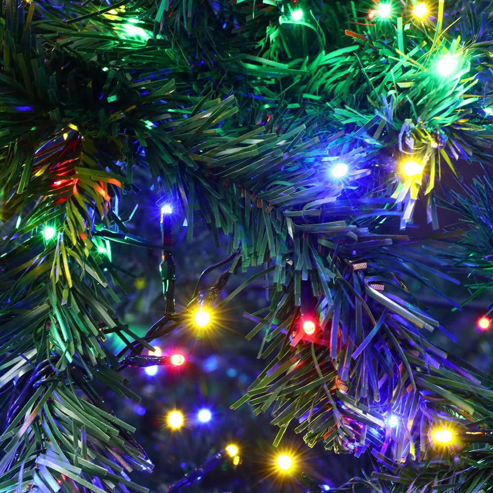 Jingle Jollys 2.4M LED Christmas Tree with multicoloured lights and bushy branches, set up for festive decorations.