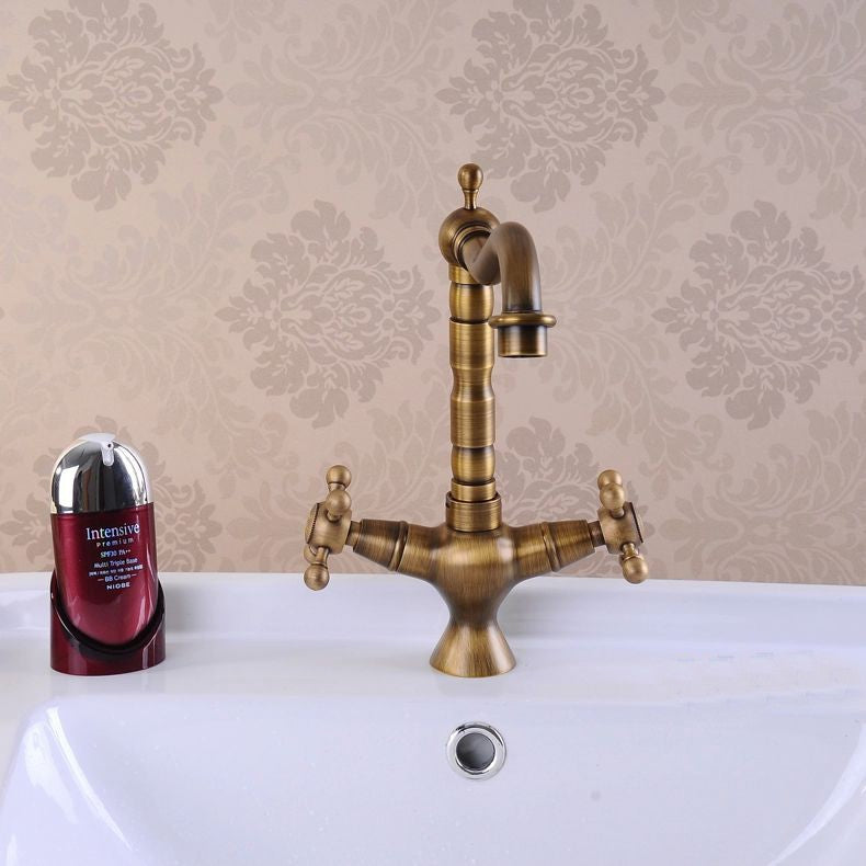 Antique bronze brass kitchen faucet with dual handles and 360-degree rotating spout, showcasing elegant design and durable construction.