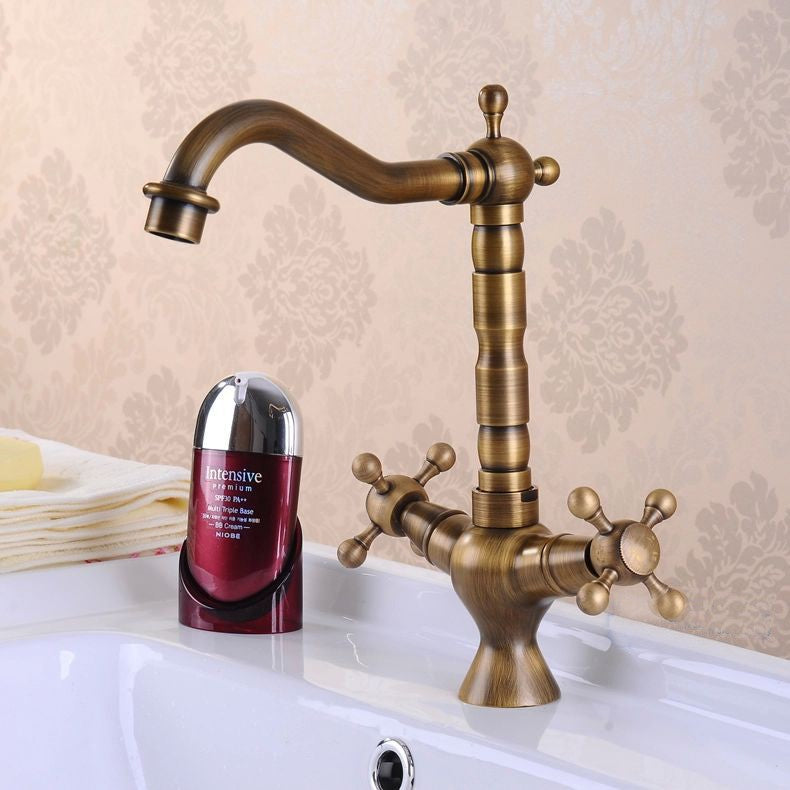 Antique bronze brass kitchen faucet with dual handles and 360-degree rotating spout, showcasing elegant design and durable construction.