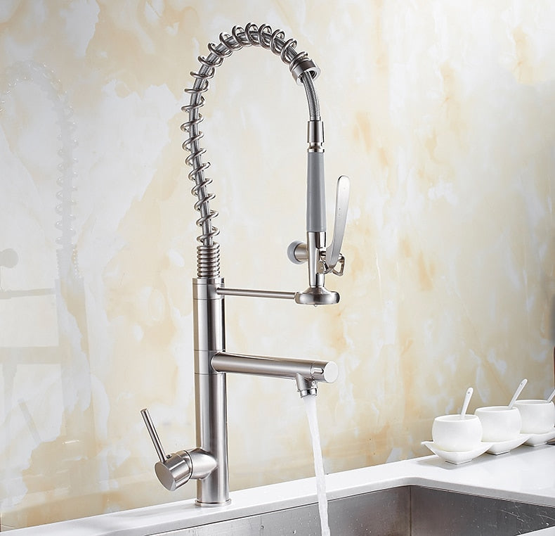 Chrome brass tall kitchen faucet with pull-out spray and single handle, featuring a modern design and 360-degree swivel spout.