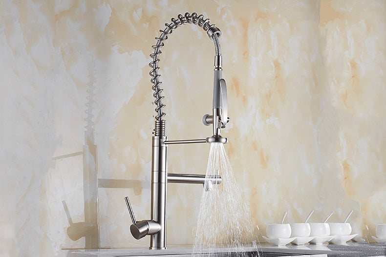 Chrome brass tall kitchen faucet with pull-out spray and single handle, featuring a modern design and 360-degree swivel spout.