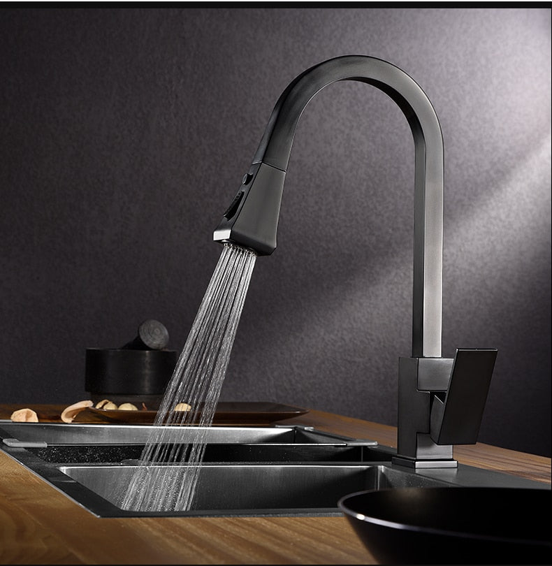 A sleek silver kitchen faucet with a pull-out tap and single hole handle, made of solid brass, featuring a 360-degree swivel design.