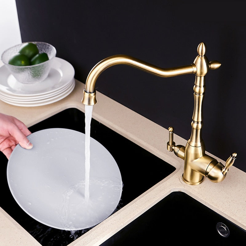 Gold mixer tap with 360-degree rotation and dual handles for hot and cold water, featuring water purification for kitchen use.