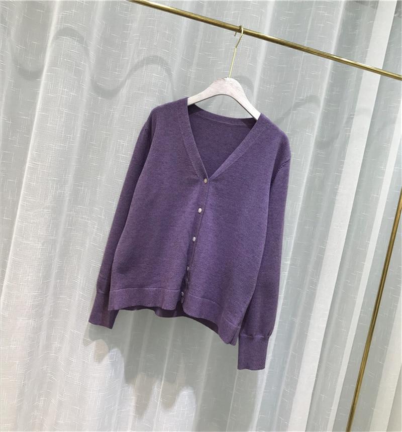 A cozy oversized knitted cardigan sweater in solid color, featuring a V-neck collar and button closure, perfect for spring and autumn wear.