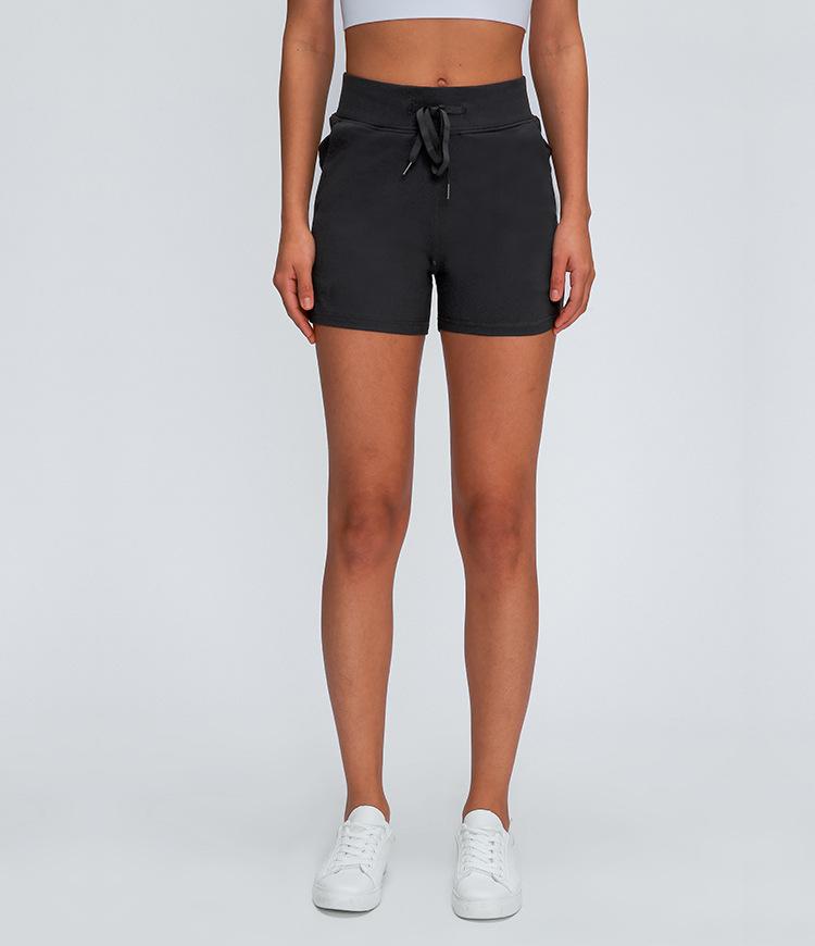 Women wearing Leisure Nylon Yoga Gym Workout Shorts, showcasing high waist design and anti-sweat fabric in a fitness setting.