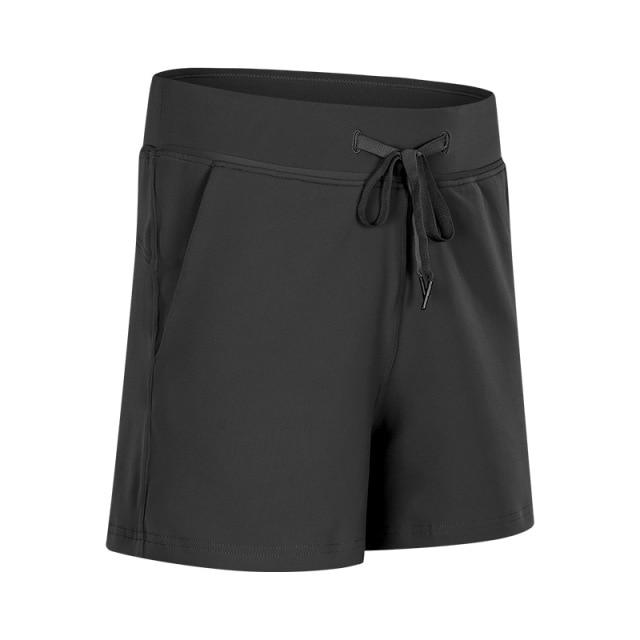 Women wearing Leisure Nylon Yoga Gym Workout Shorts, showcasing high waist design and anti-sweat fabric in a fitness setting.