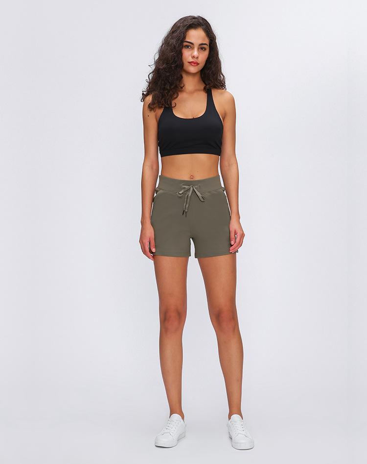 Women wearing Leisure Nylon Yoga Gym Workout Shorts, showcasing high waist design and anti-sweat fabric in a fitness setting.