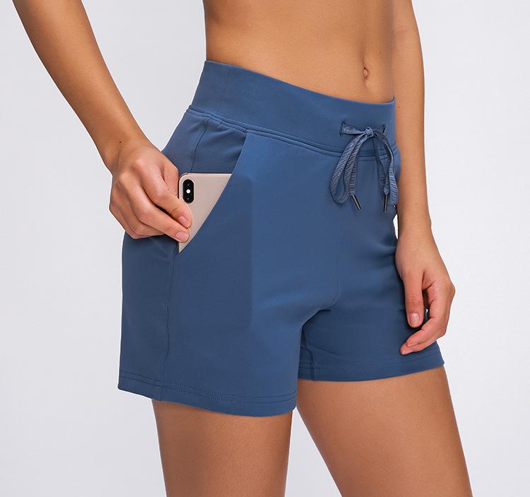 Women wearing Leisure Nylon Yoga Gym Workout Shorts, showcasing high waist design and anti-sweat fabric in a fitness setting.