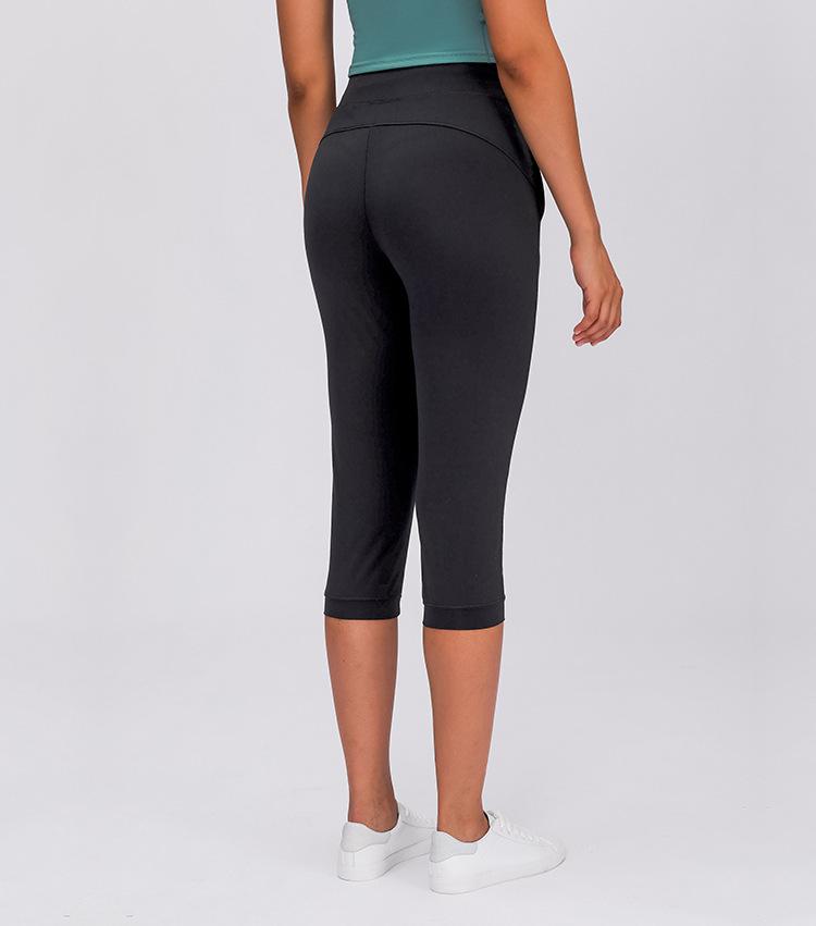 Women wearing high waist yoga capri joggers, showcasing stretchy fabric and side pocket.