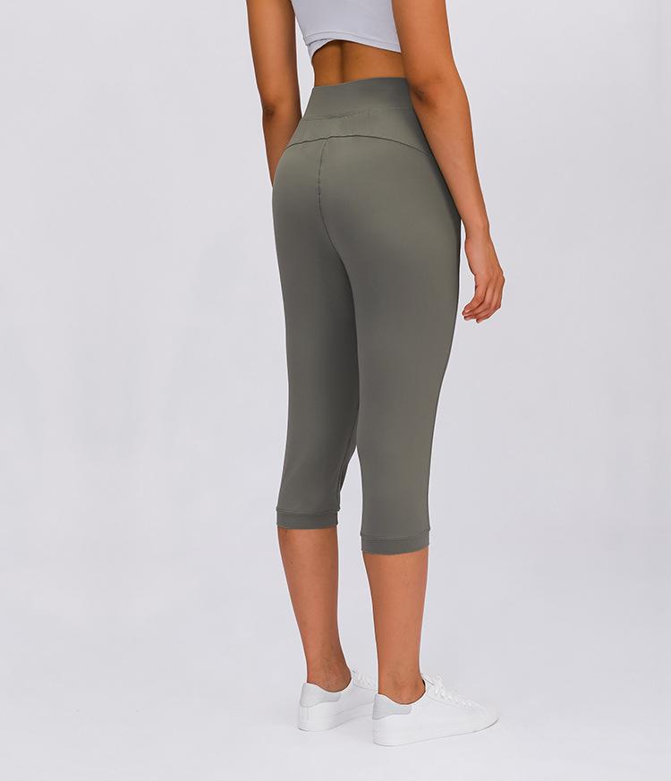 Women wearing high waist yoga capri joggers, showcasing stretchy fabric and side pocket.