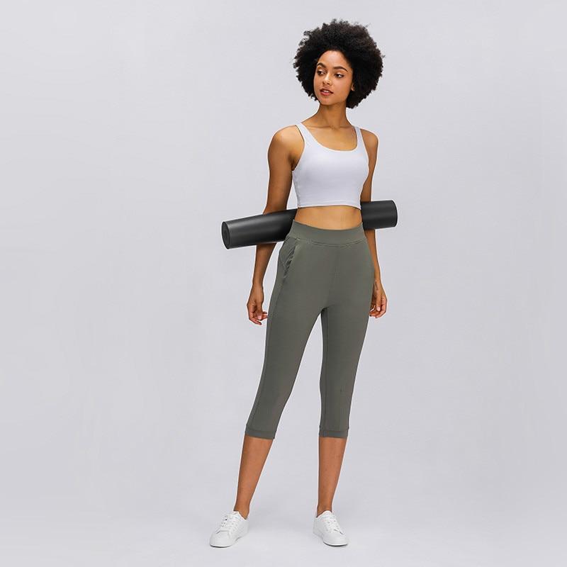 Women wearing high waist yoga capri joggers, showcasing stretchy fabric and side pocket.