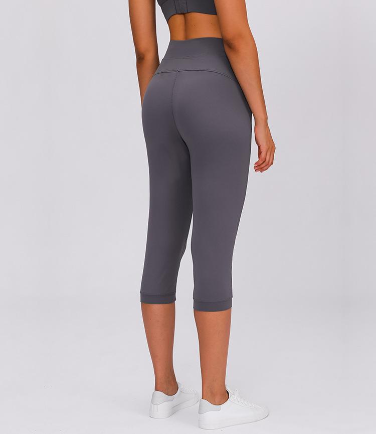 Women wearing high waist yoga capri joggers, showcasing stretchy fabric and side pocket.