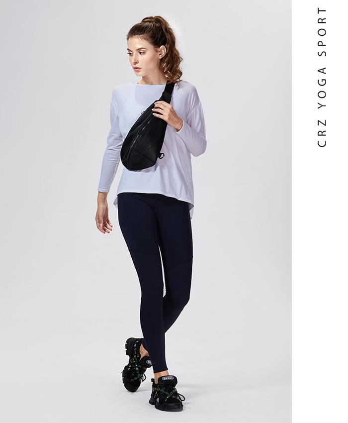 A woman wearing a loose fit long sleeve workout shirt made of Pima cotton, perfect for yoga and casual outings.