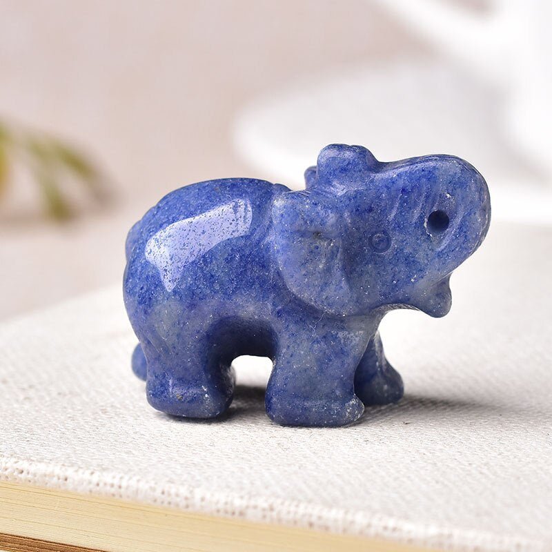 A beautifully hand-carved Lucky Crystal Elephant figurine with a raised trunk, showcasing intricate details and sparkling facets in various colors.