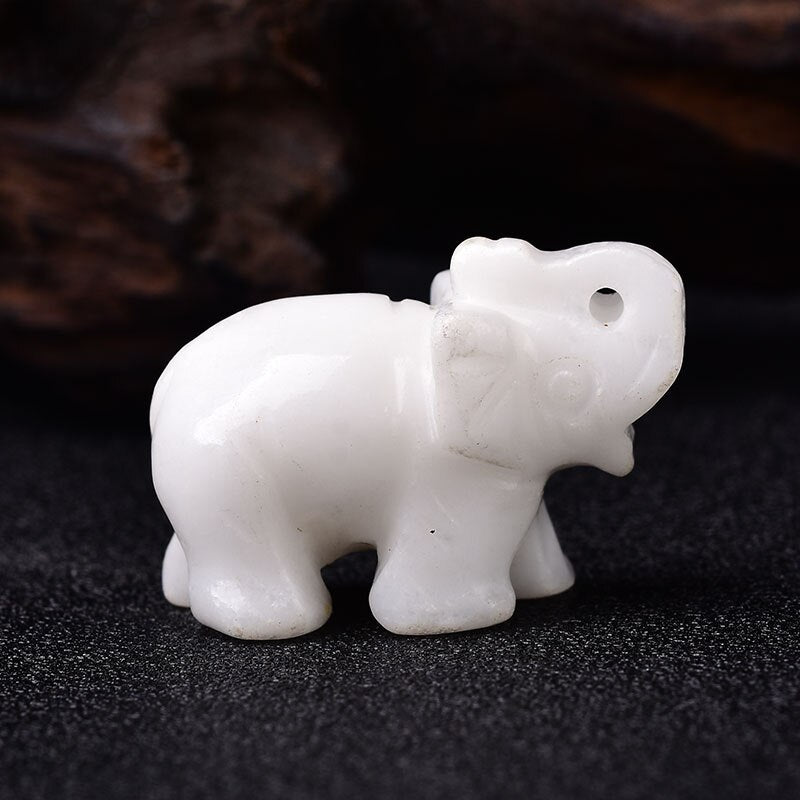 A beautifully hand-carved Lucky Crystal Elephant figurine with a raised trunk, showcasing intricate details and sparkling facets in various colors.