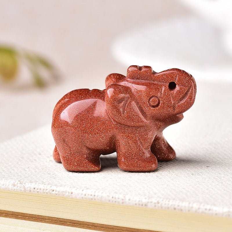 A beautifully hand-carved Lucky Crystal Elephant figurine with a raised trunk, showcasing intricate details and sparkling facets in various colors.